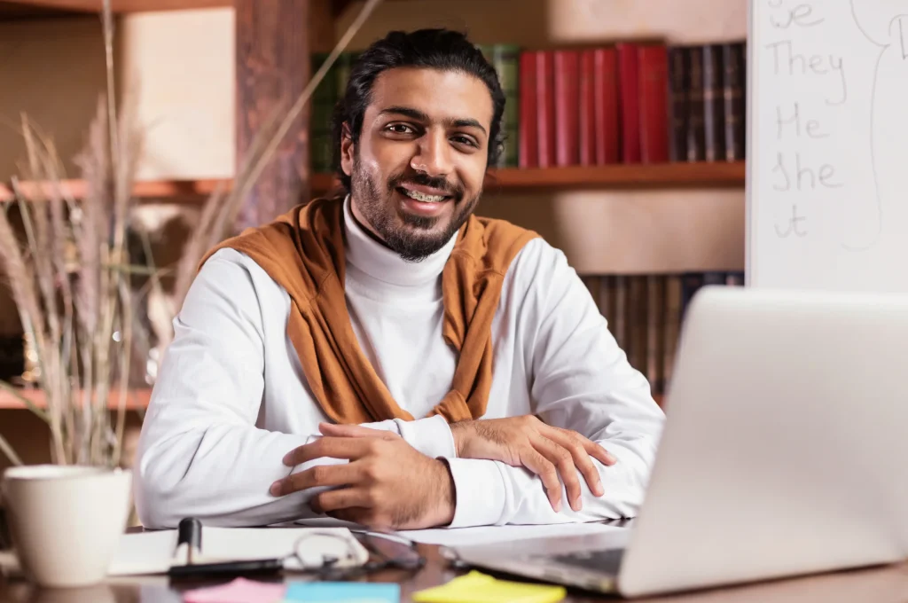successful-indian-teacher-sitting-at-laptop-posing-2025-03-18-18-05-46-utc (3)