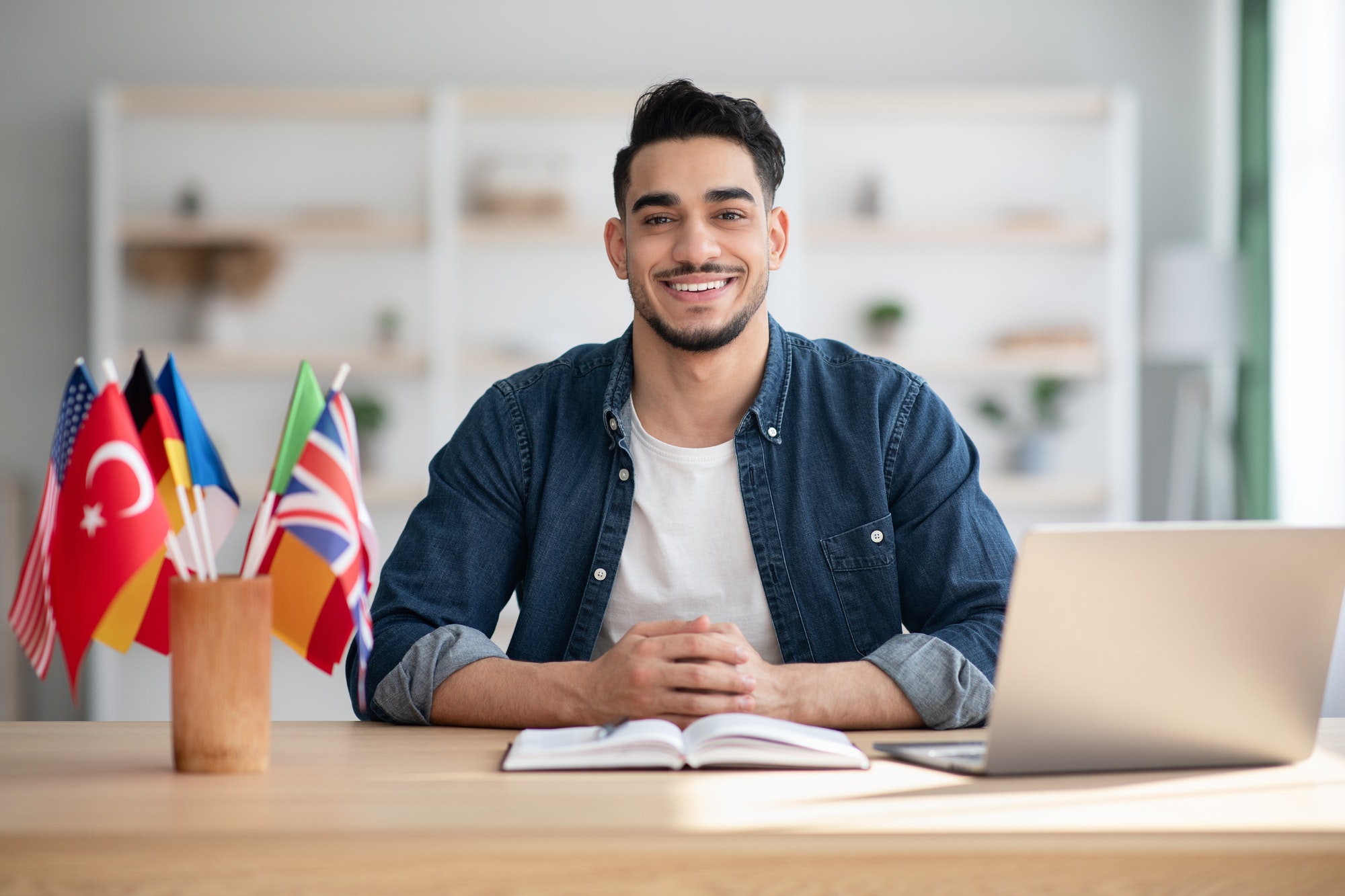 cheerful-arab-guy-having-online-class-on-laptop-at-home.jpg